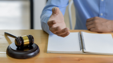 Close-up shot of Hammer on the table and lawyer introducing law, Concept of law.